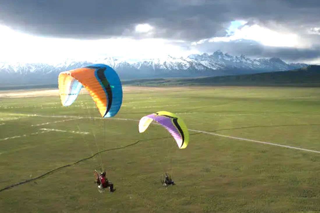 Two paramotors in the air